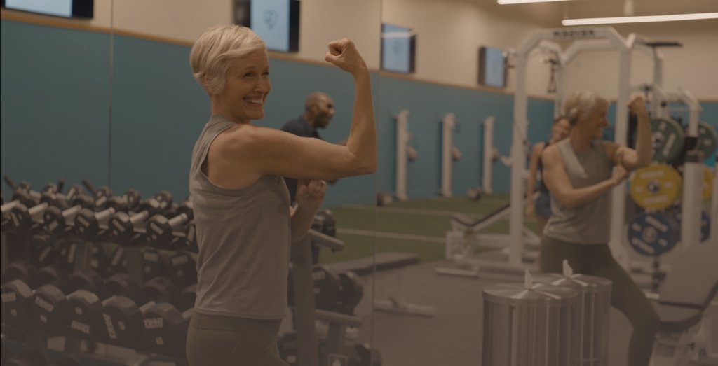 Woman Flexing in Gym